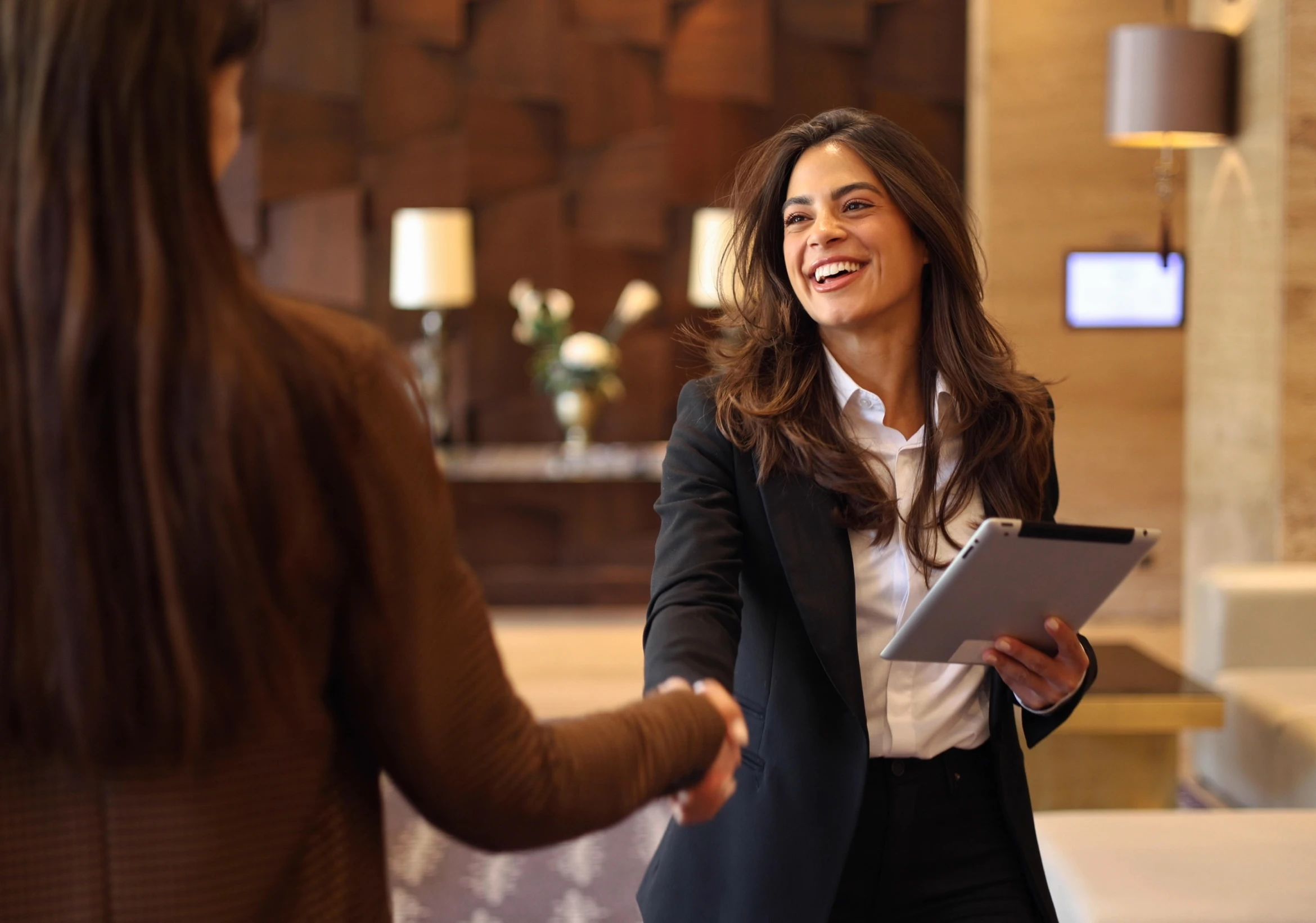 Businesswoman shaking hands in modern office